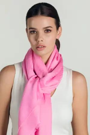 Croata scarf in red and blue tones on a red background, elegantly draped to highlight its luxurious texture and intricate design
